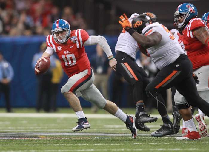 Jan 1, 2016; New Orleans, LA, USA; Mississippi Rebels quarterback Chad Kelly (10) carries the ball against the Oklahoma State Cowboys during the third quarter in the 2016 Sugar Bowl at the Mercedes-Benz Superdome. Mandatory Credit: Crystal LoGiudice-USA TODAY Sports